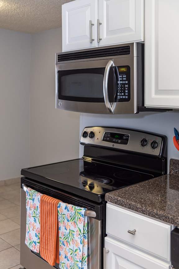 A black stove top oven with a microwave above it.