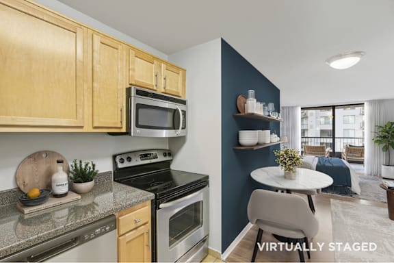 A kitchen with wooden cabinets and a black stove top oven.