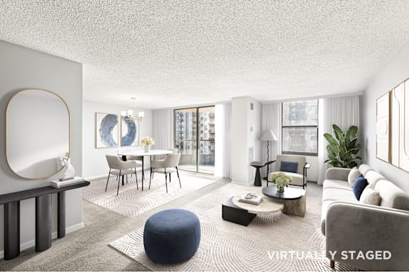 A modern living room with a dining area and a large window.