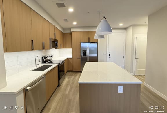 A modern kitchen with wooden cabinets and a central island.