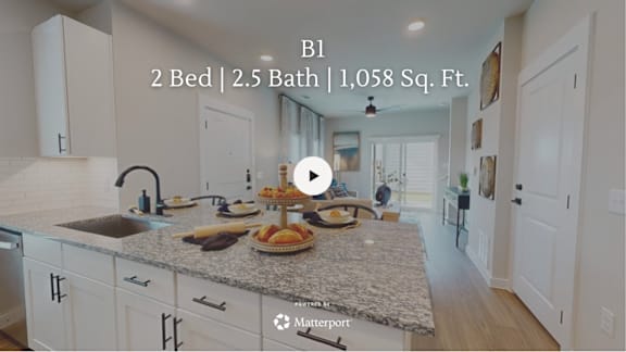 A kitchen with a countertop and a sink, with a video player overlay.