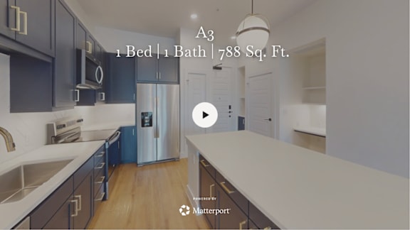 A kitchen with dark cabinets and a stainless steel refrigerator.