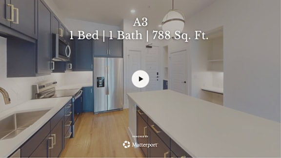 A kitchen with dark cabinets and a stainless steel refrigerator.