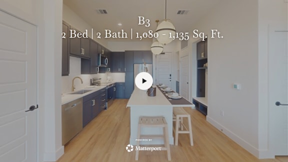 A kitchen with a video play button overlay.