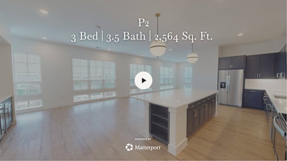 A kitchen with a play button overlay.