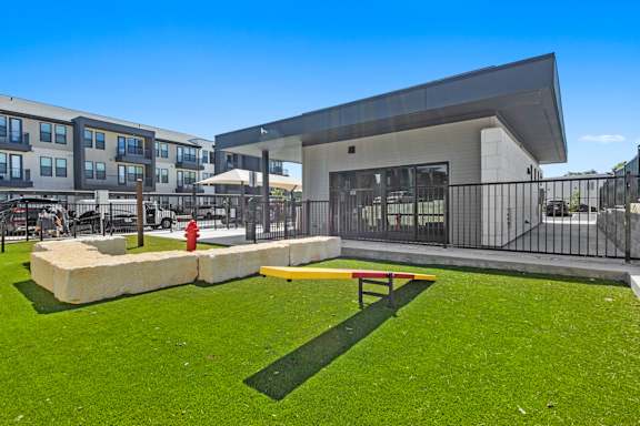 a courtyard with a fire hydrant and a building with a patio and a playground