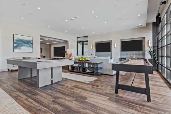 a large living room with a kitchen and a dining table