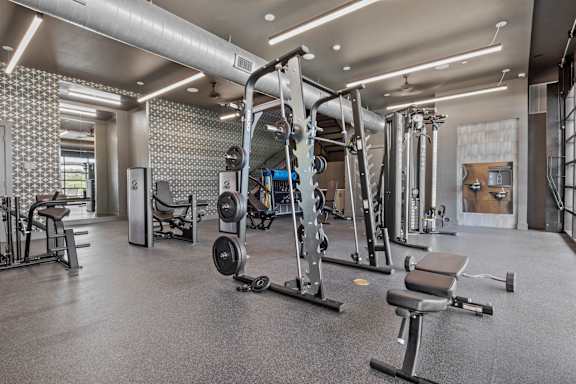 a gym with weights and other exercise equipment in a building