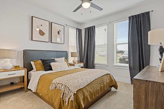 a bedroom with a bed and a ceiling fan