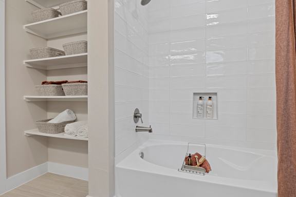 a white bathroom with a tub and a shower