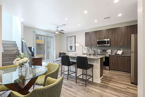 A modern kitchen with a dining table and chairs at Scottsdale Hayden Townhomes, Scottsdale, AZ, 85257