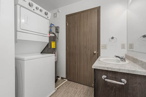 A small bathroom with a washer and dryer in it.