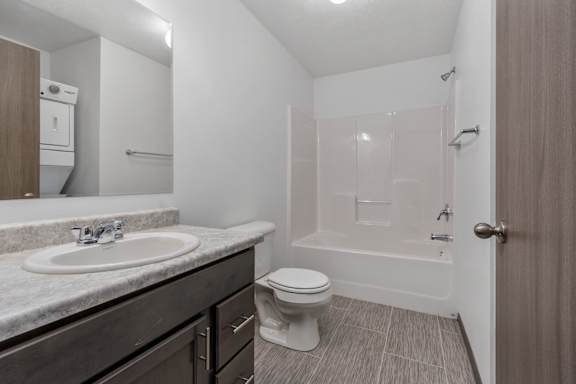 A bathroom with a sink, toilet, and bathtub.