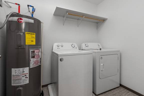 A small laundry room with a washer and dryer.