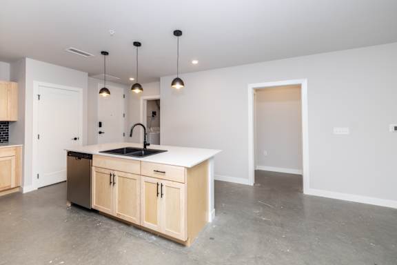 A kitchen with a sink and a counter.