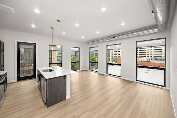 A spacious kitchen with a large island and a view of the city.