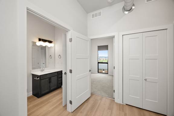 A bathroom with a sink, mirror, and a window.