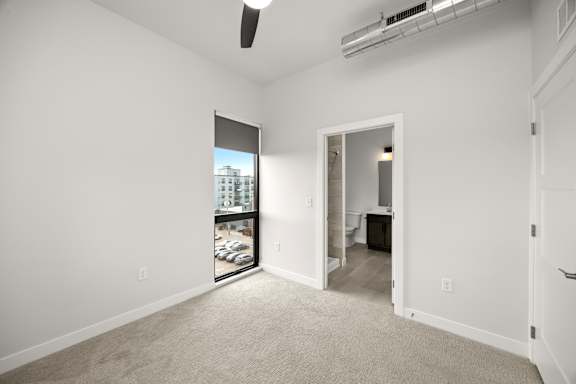 A room with a window and a ceiling fan.