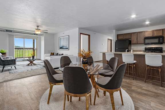 A modern dining room with a glass table and chairs.