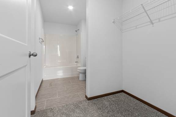 A bathroom with a toilet, sink, and bathtub.