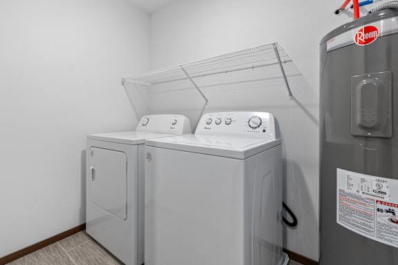 A Keepsink refrigerator is in a laundry room with a washer and dryer.