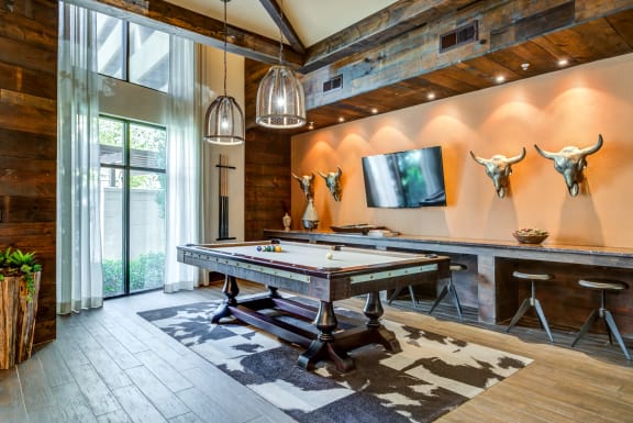 a game room with a pool table and a tv at Aviator West 7th, Texas, 76107