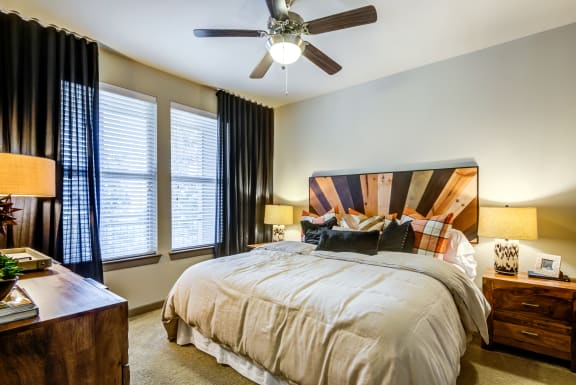 a bedroom with a large bed and a ceiling fan at Aviator West 7th, Fort Worth