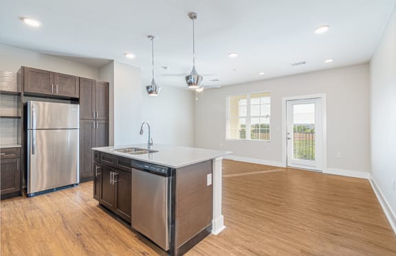a kitchen with a large island and a stainless steel refrigerator at The Fitzroy San Marcos, San Marcos