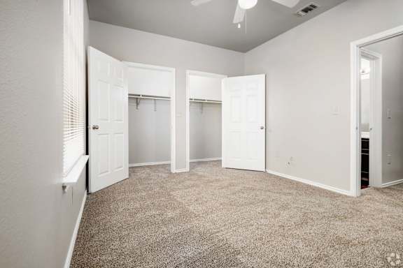 A room with white doors and a carpeted floor.