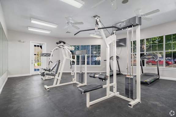 Fitness center with cable machines and treadmill at Houston Street Townhomes Apartments, San Antonio, Texas