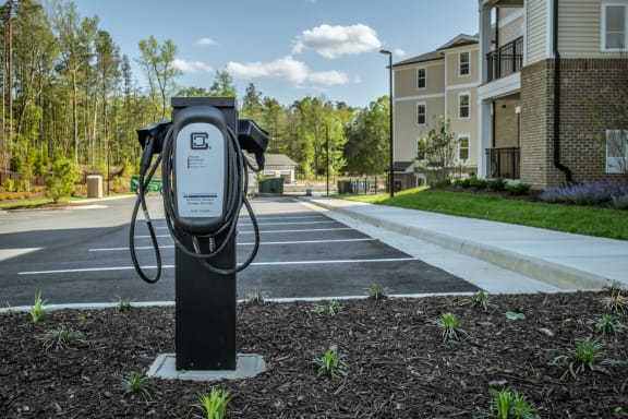 a public charger in a parking lot at the whispering winds apartments in pearland, tx