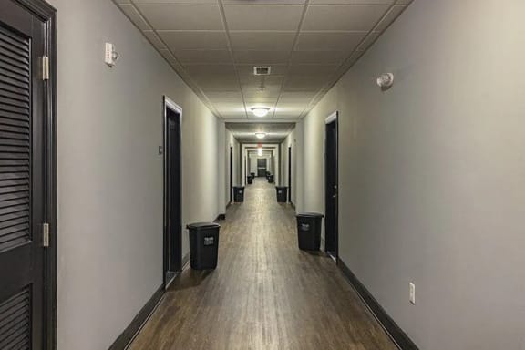 a hallway in a building with a wooden floor