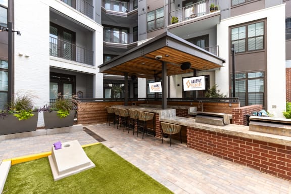 a large patio with a bar and a brick wall at Abberly Foundry Apartment Homes, Nashville