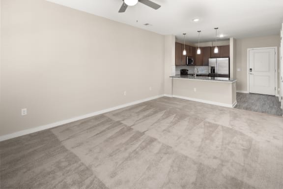an empty living room and kitchen in a new home at Abberly Liberty Crossing Apartment Homes, Charlotte