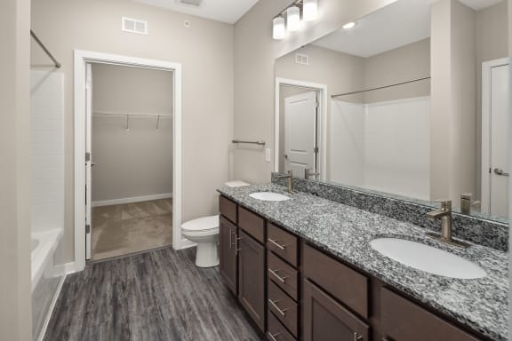 a bathroom with granite counter tops and a shower and toilet at Abberly Liberty Crossing Apartment Homes, Charlotte, NC, 28269