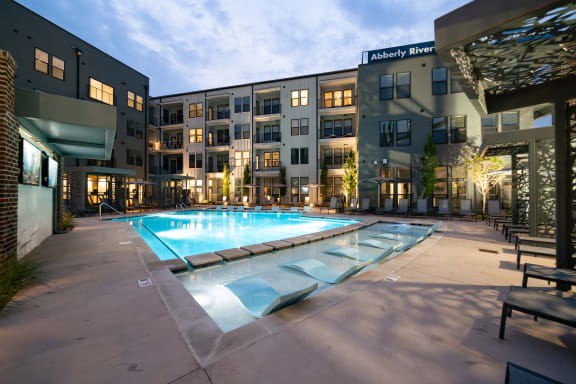 an apartment complex with a swimming pool in front of it  at Abberly Riverwalk Apartment Homes, Nashville, 37228