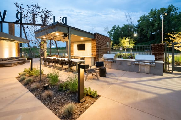 a patio with a grill and a table and chairs at Abberly Riverwalk Apartment Homes, Nashville, TN, 37228