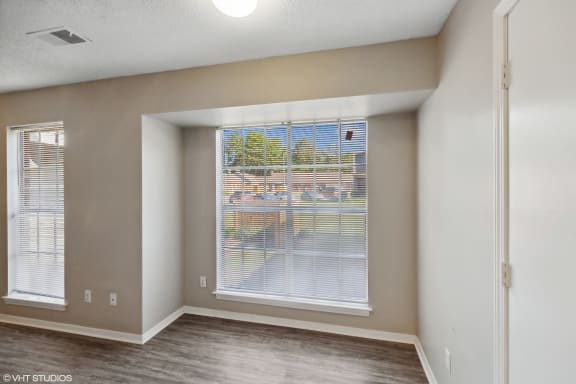 an empty living room with a large window at The Birches Apartment Homes, Tennessee