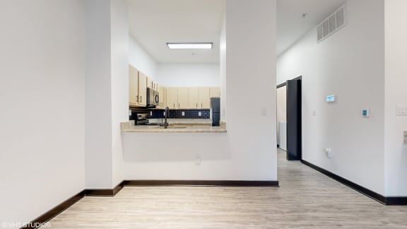 an empty hallway with a kitchen and an open door to a room at Bristol On Union Apartment Homes, Tennessee, 38104