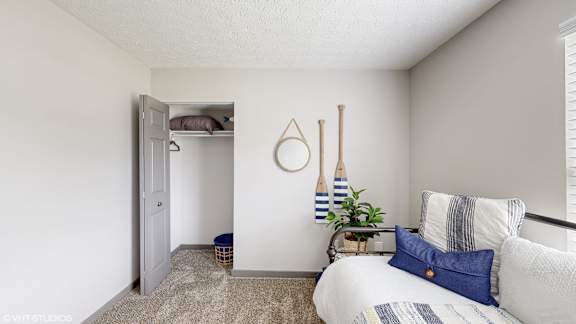 a bedroom with a bed and a closet with a white door