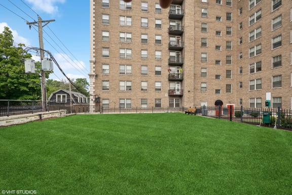 a large yard in front of a tall building at CWE Apartments, St. Louis, 63108