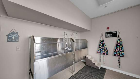 A room with a stainless steel tank and a sign that says