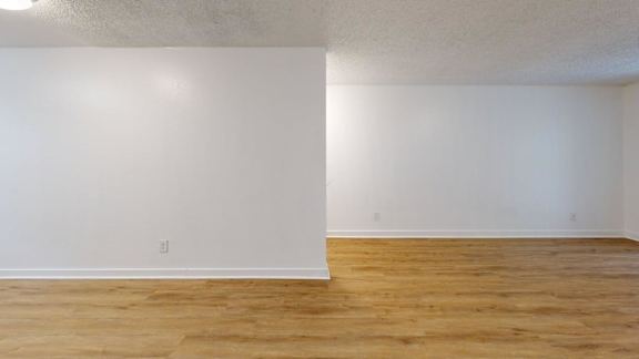A room with wooden floors and white walls.