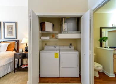 a small closet with a washer and dryer in it