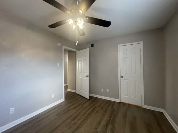 the living room of an empty house with a ceiling fan at Whispering Oaks, Conroe, 77301 ?