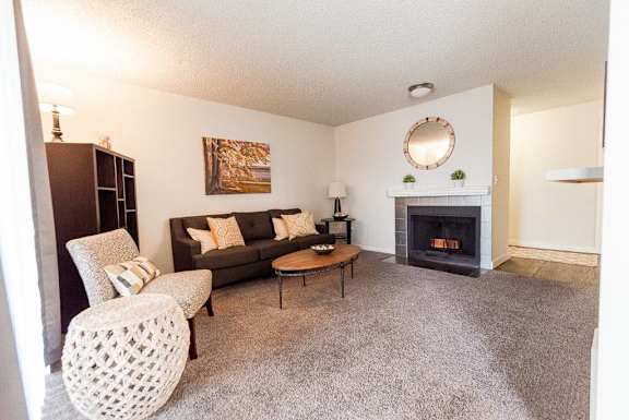 A living room with a fireplace and a couch.