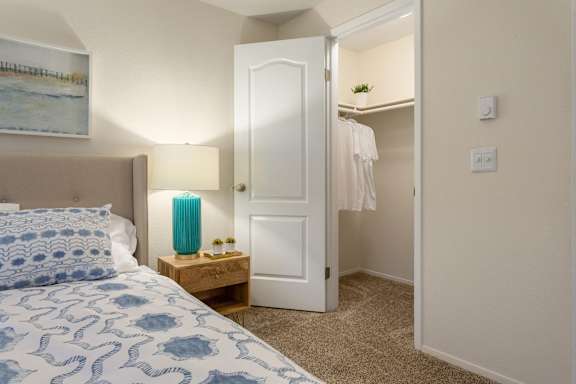 Walk-in closet with organized shelving and hanging space at Bower Village Apartments, Kent, 98030