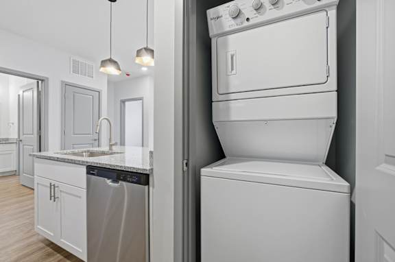 A modern kitchen with a washing machine and dishwasher.