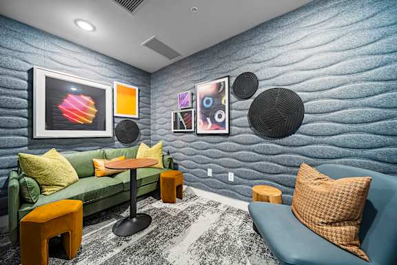 A living room with a blue couch and a green couch.