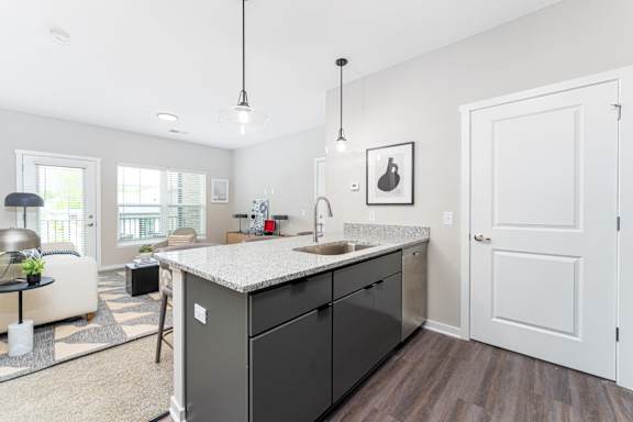 A kitchen with a sink and a counter.